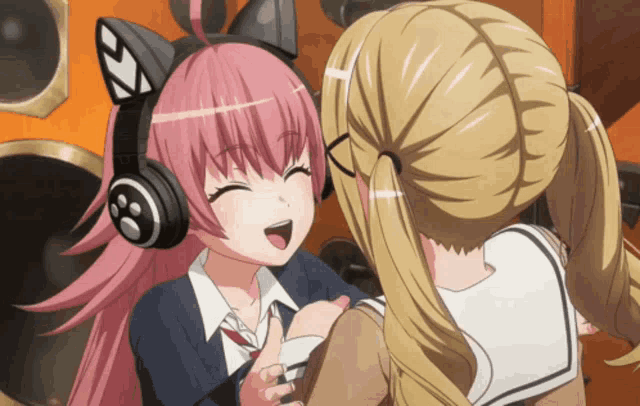 two anime girls are hugging each other and one has headphones on her head