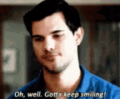 a man in a blue shirt is smiling and says `` oh well , gotta keep smiling ! ''