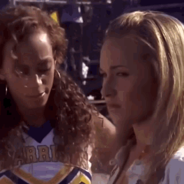 a cheerleader wearing a jersey that says warriors