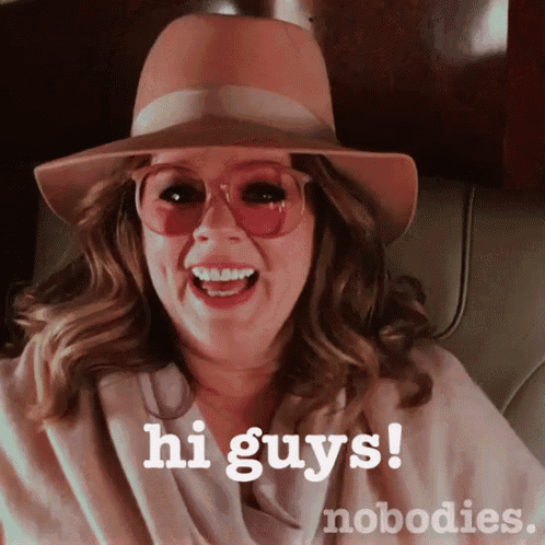 a woman wearing a hat and sunglasses says hi guys and nobodies