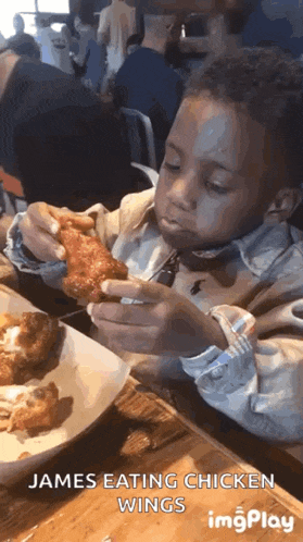 a young boy eating chicken wings with the caption james eating chicken wings imgplay