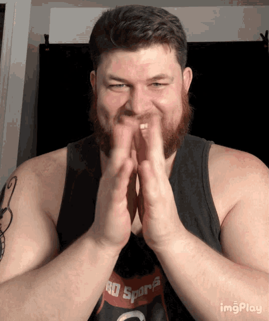 a man with a beard wears a shirt that says 80 sports on it
