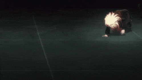 a person is kneeling on the floor with their head down