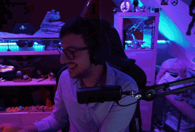 a man wearing headphones and a racing chair