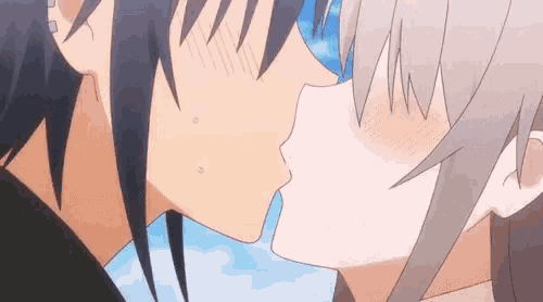 a boy and a girl are kissing in a cartoon .