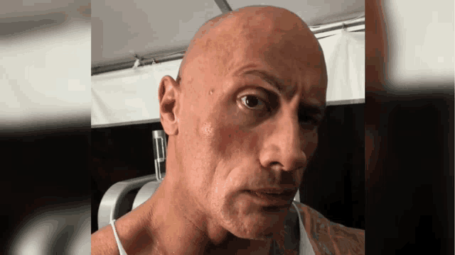 a close up of a man 's face with a tattoo on his chest