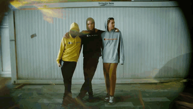 three men are posing for a picture in front of a white wall that says petrovice beo