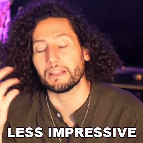 a man with curly hair and a beard is making a less impressive gesture