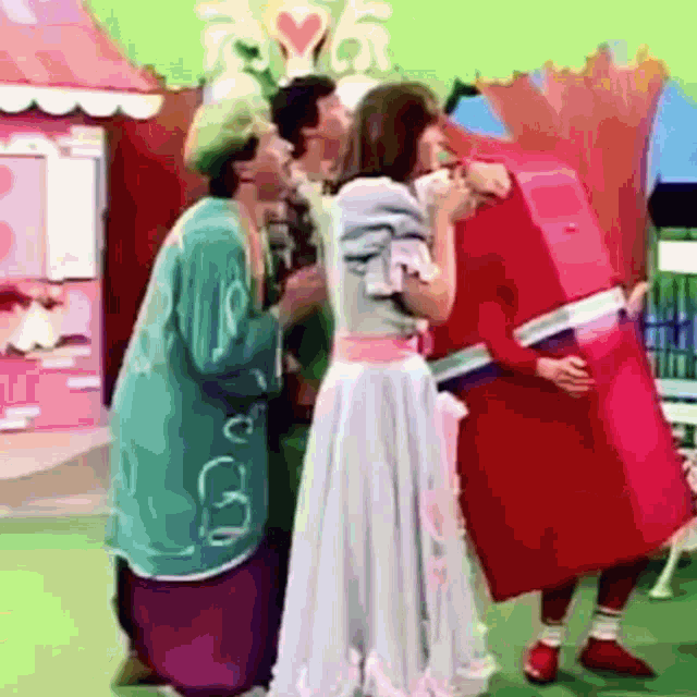 a group of people are standing next to each other and one of them is dressed as a candy bar .