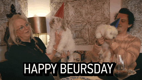 a man and a woman holding two small white dogs with the words happy beursday below them