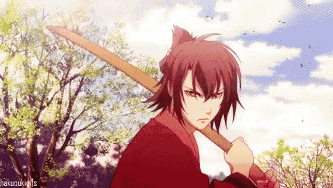 a man in a red shirt is holding a wooden sword .