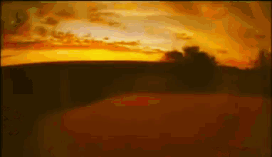 a painting of a sunset with a few trees in the foreground
