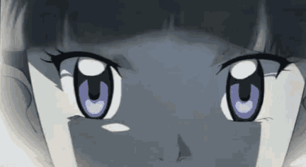 a close up of a girl 's eyes with purple eyes looking at the camera .