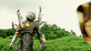 a monster is standing in a grassy field holding a gun