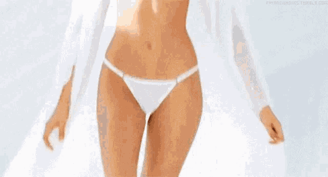a woman in a white bikini is walking on a white background .