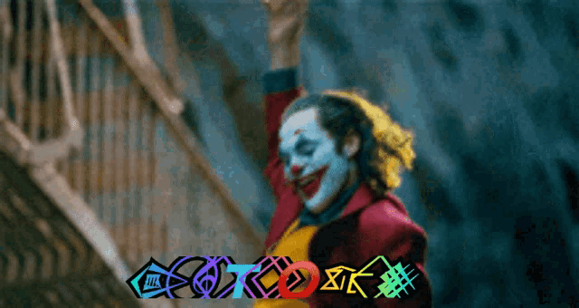 a clown is standing on a set of stairs with the word ok in the corner