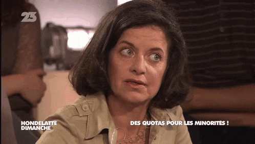 a woman is on a television screen with the number 23 on the bottom right