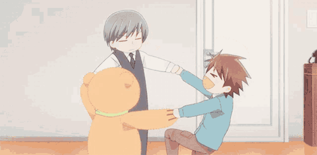 two boys are playing with a teddy bear that has a green bow on it