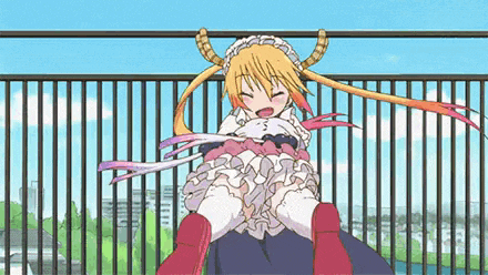 a girl with horns is sitting on a man 's shoulders on a balcony .