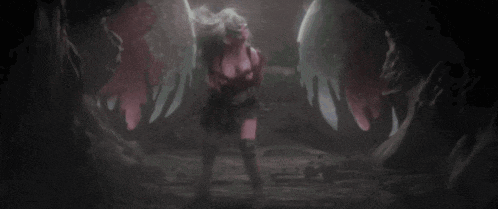 a woman in a mask is standing in a dark cave .