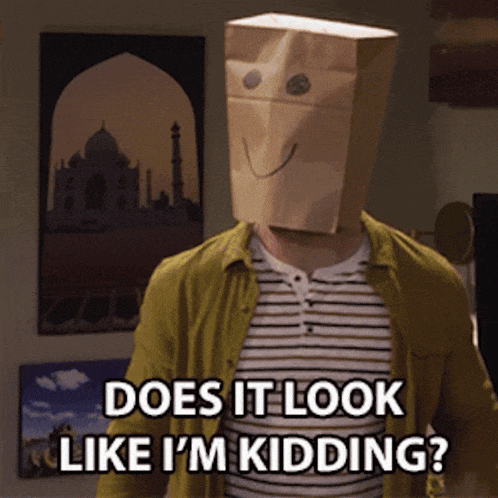 a man wearing a paper bag on his head says does it look like i 'm kidding