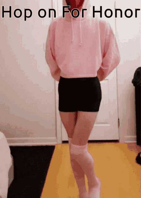a girl in a pink hoodie and pink knee high socks is standing in front of a door with the caption hop on for honor