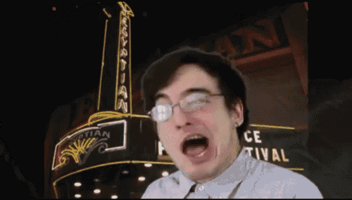 a man making a funny face in front of a sign that says " egyptian "