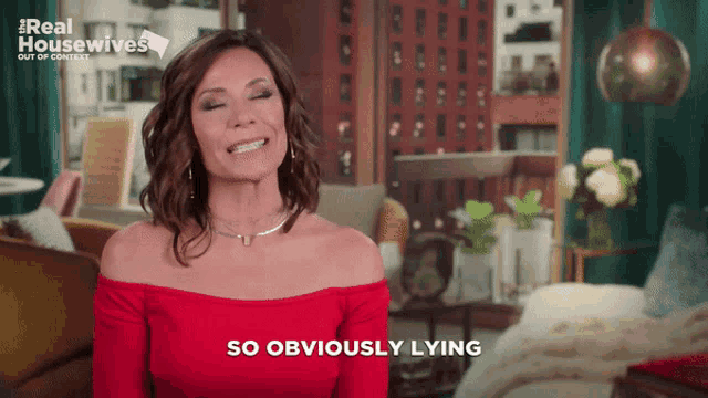 a woman in a red off the shoulder top is smiling and says so obviously lying