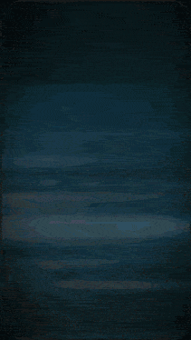 a blurred image of a person 's face with a blue background