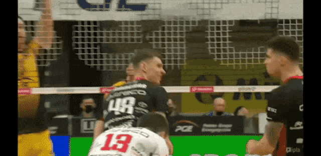 a volleyball player with the number 13 on his jersey