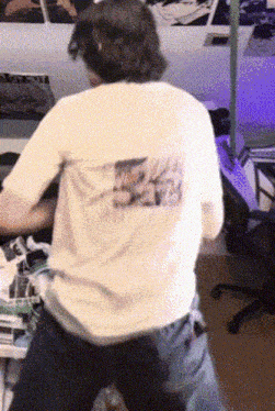a person wearing a white t-shirt with a picture on the back of it