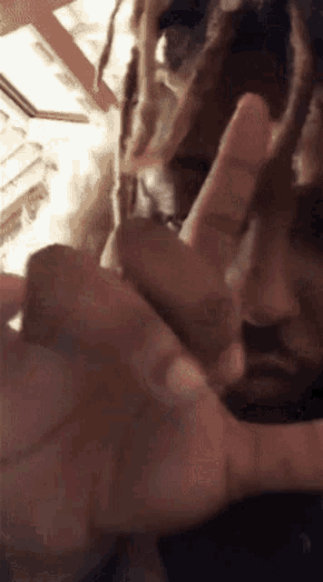 a close up of a person 's hand making a peace sign with their fingers