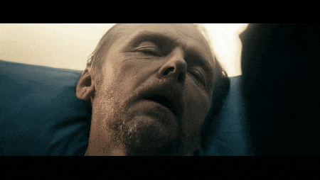 a man with a beard is laying in a hospital bed