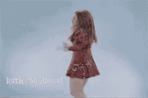 a woman in a red dress is dancing with the words `` rath can dance '' behind her .
