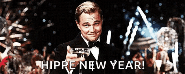 a man in a tuxedo is pointing at the camera with the words hippre new year written below him