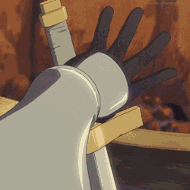 a close up of a person holding a sword with their hand