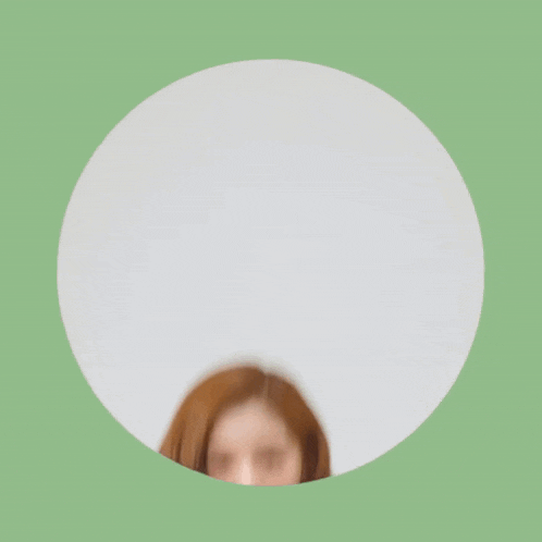 a woman with red hair and green nails looks surprised