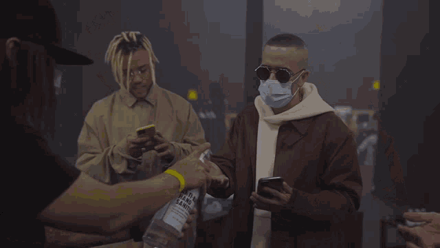 a man wearing a mask is holding a can of alcohol