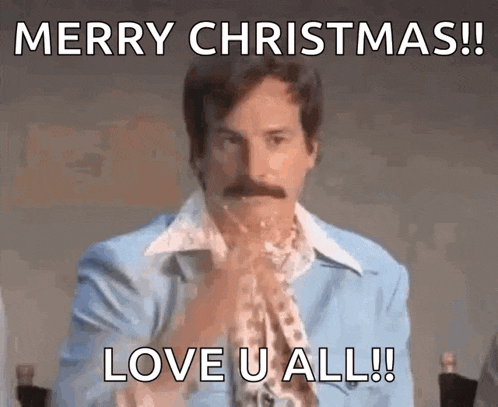 a man in a blue suit with a mustache says merry christmas love u all !