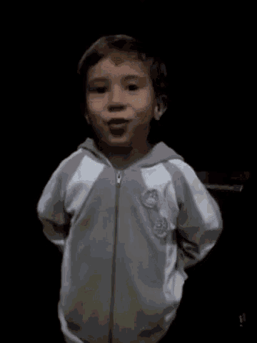 a young boy wearing a grey and white jacket with the words tuuuudooo puuuutaa !!! below him