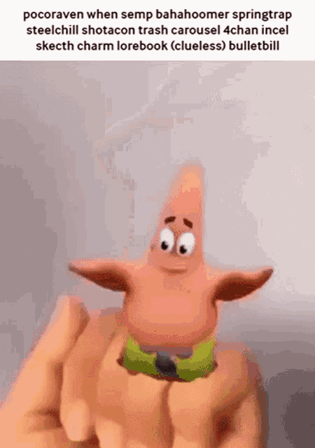 a person is holding a small cartoon character in their hand .