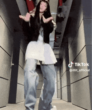 a woman is dancing in a hallway with a tiktok watermark on the bottom