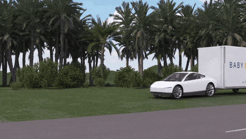 a white car is pulling a white box that says baby