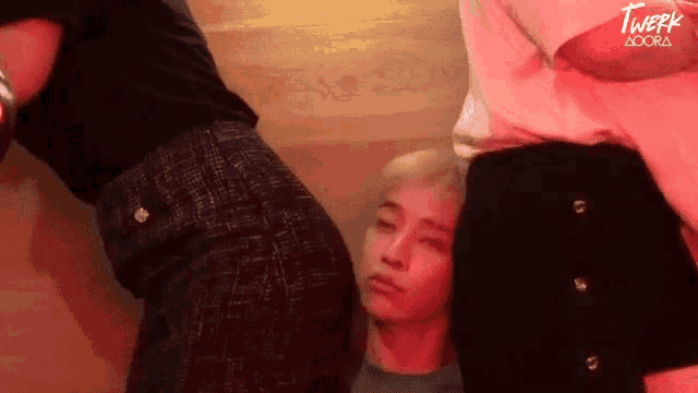 a man and a woman are standing next to each other and one of them is looking down at the other 's butt .