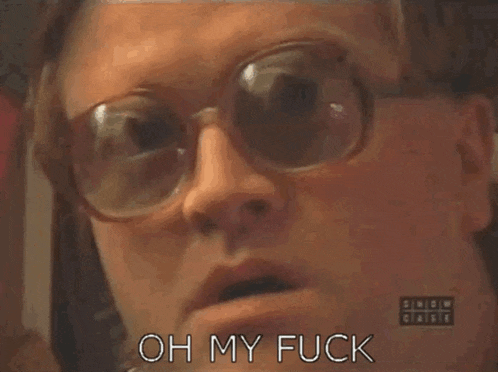 a close up of a person wearing glasses and saying oh my fuck