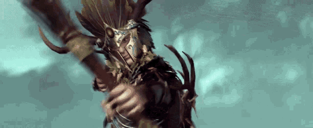 a man in a feathered helmet is holding a spear in his hand .