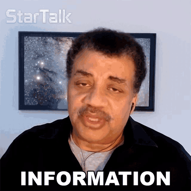 a man in front of a framed picture with the word information on it