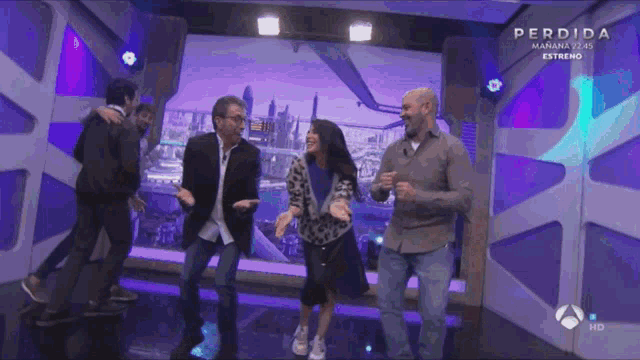 a group of people are dancing in front of a screen that says " perdida "