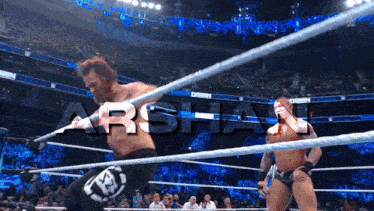 two wrestlers in a wrestling ring with the word arshau on the screen