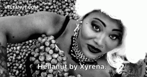 a black and white photo of a woman laying on a pile of nuts with the words hellanut by xyrena written below her
